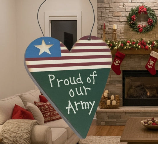 Decorated living room with Christmas tree, stockings, and a heart-shaped sign with 'Proud of our Army' text.