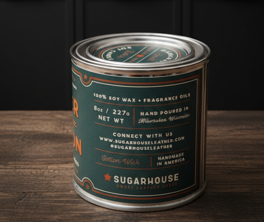 Candle canister with 'Sugarhouse' branding on a wooden surface in a kitchen setting