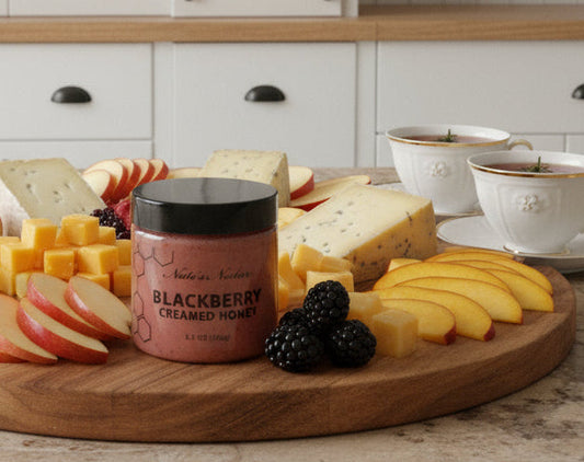 Jar of blackberry honey on a marble surface