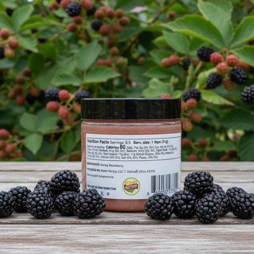 jar of blackberry honey on a table outside