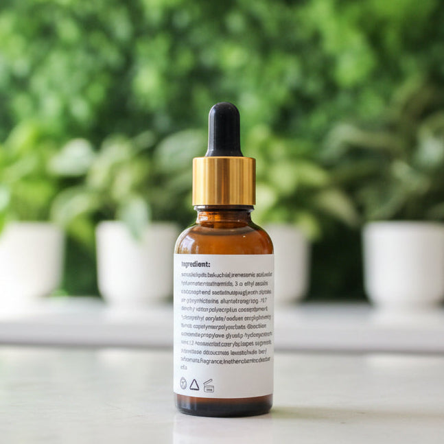 Bottle with dropper on a surface next to a box labeled 'Lee & Andre'.