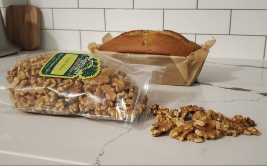 Bag of walnuts on a kitchen counter with scattered walnuts.