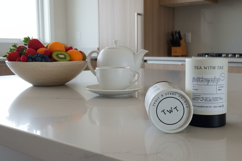 Tea with T and fruit bowl on a kitchen counter