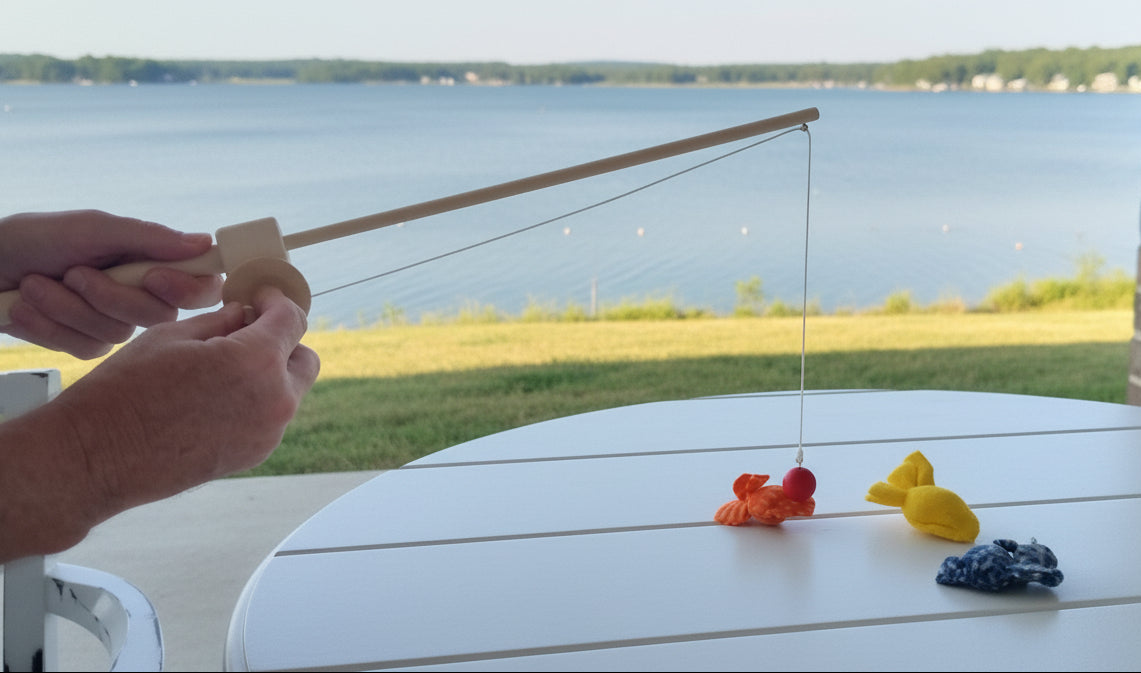 Colorful toy fish on a table with a brick wall background