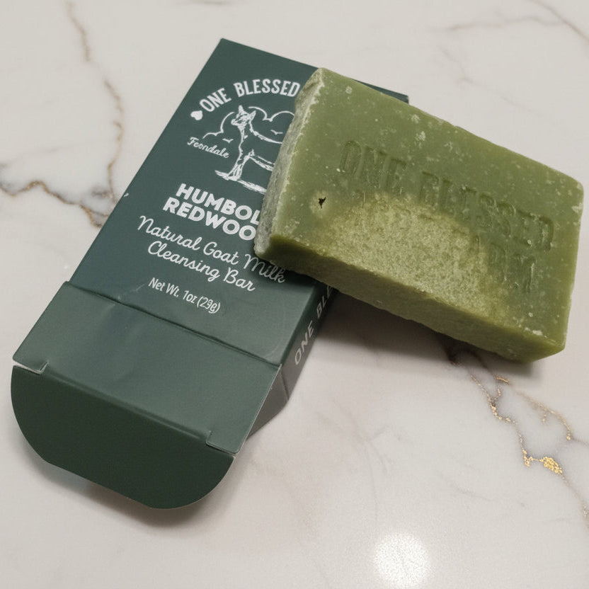 Green soap bar with packaging on a wooden surface