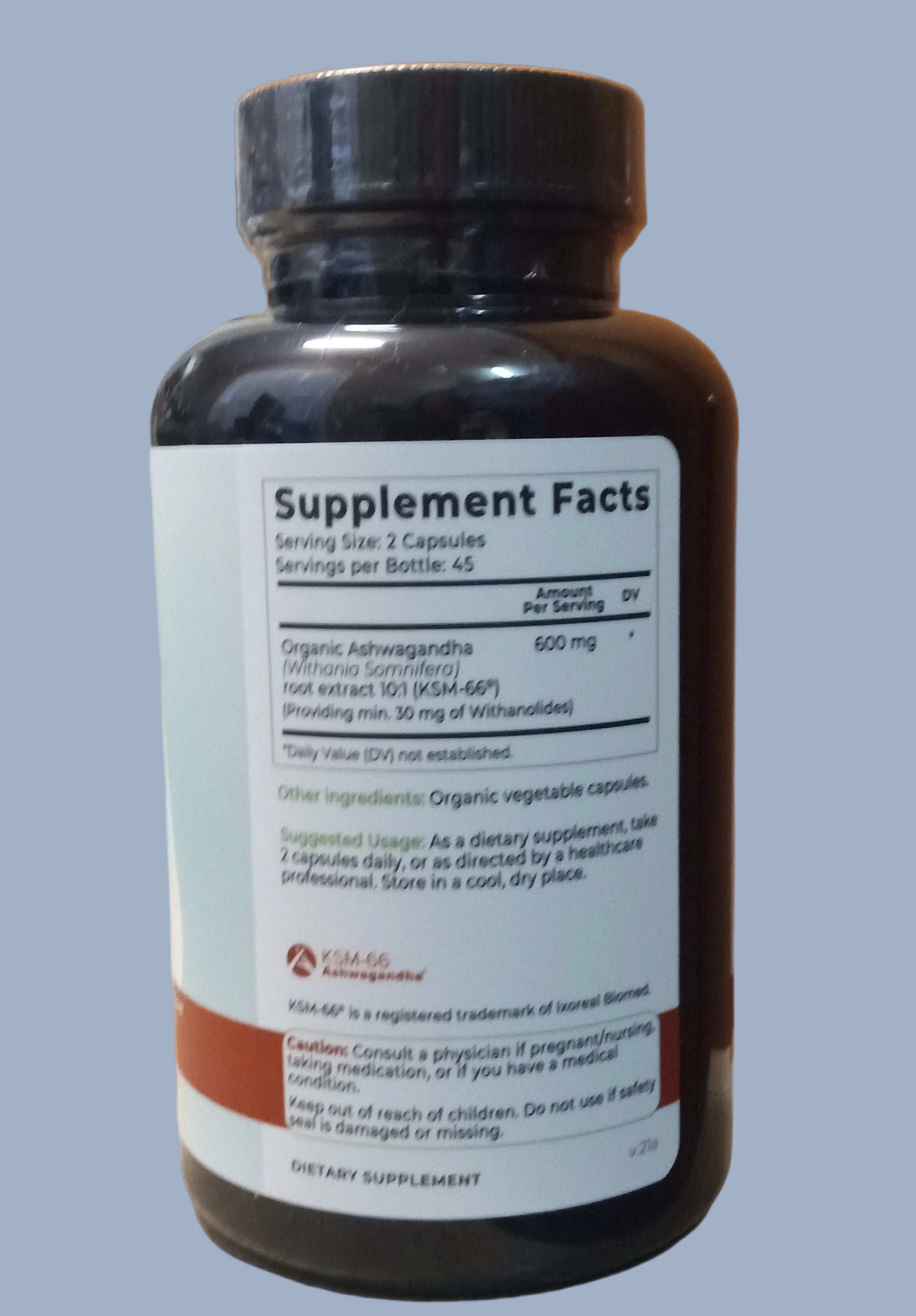 Supplement bottle with label on a wooden surface