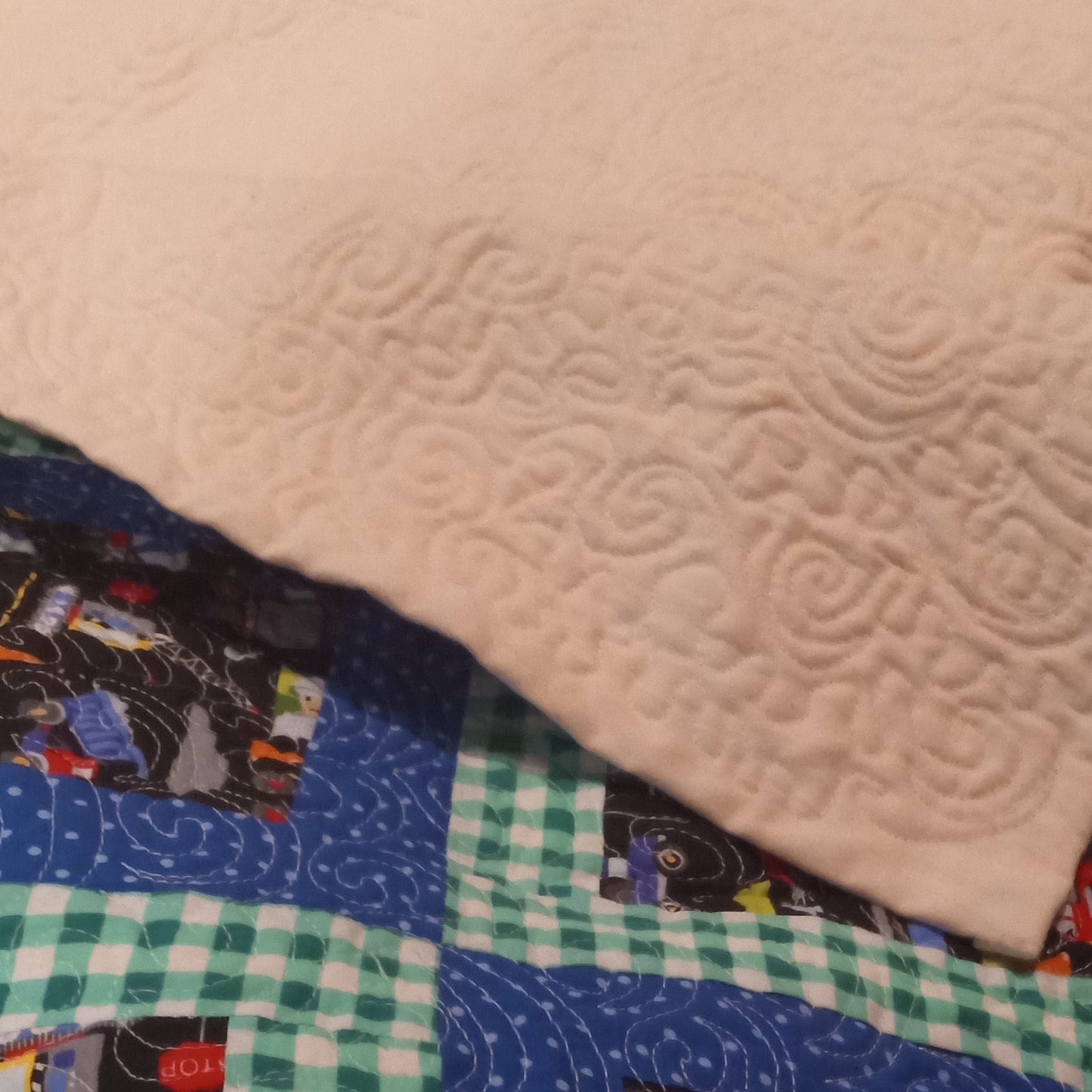 Close-up of a quilt with colorful patterns and textures.