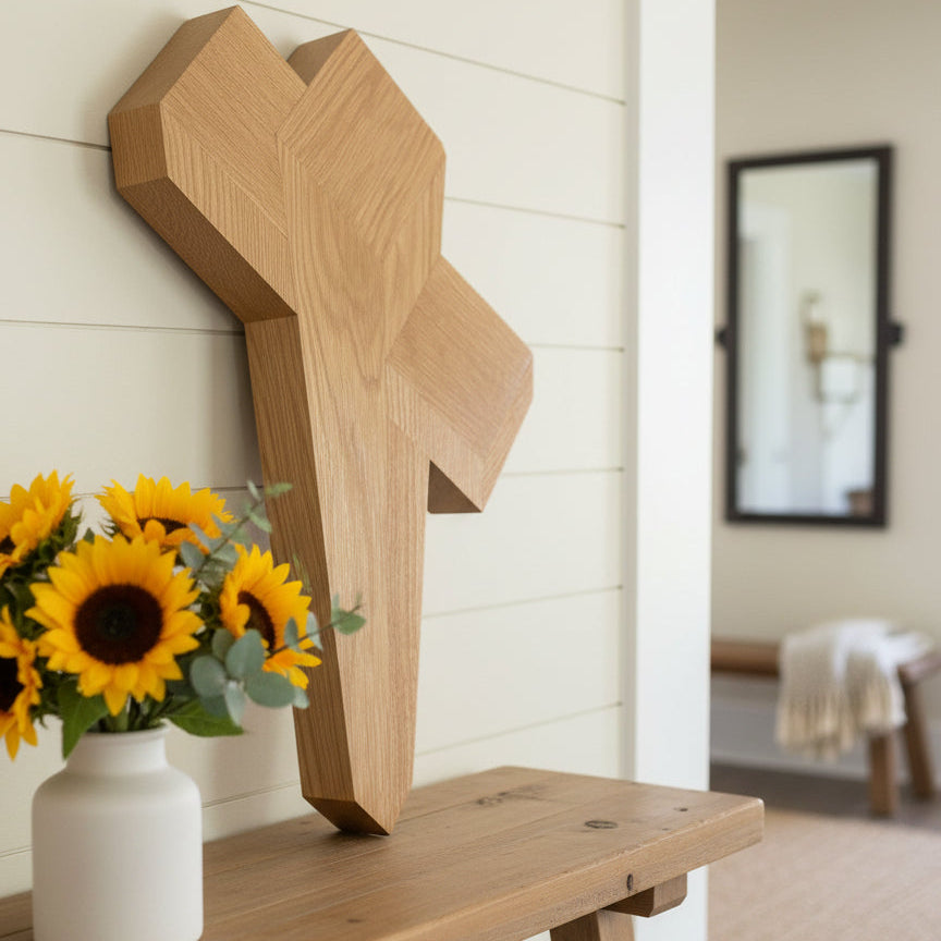 Wooden decorative item on a dark surface with a plant in the corner