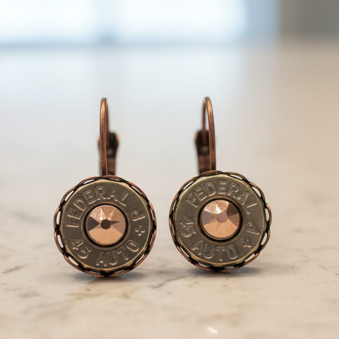 Bullet casing earrings on a wooden surface