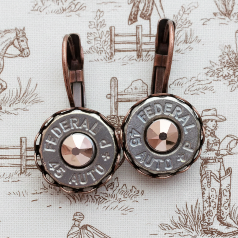 Bullet casing earrings with 'Federal' branding on a wooden surface
