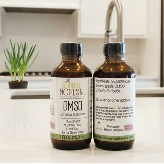 Two bottles of DMSO on a kitchen counter with wooden cabinets in the background.