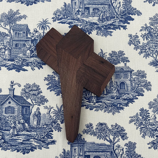 Wooden cross on a white wall