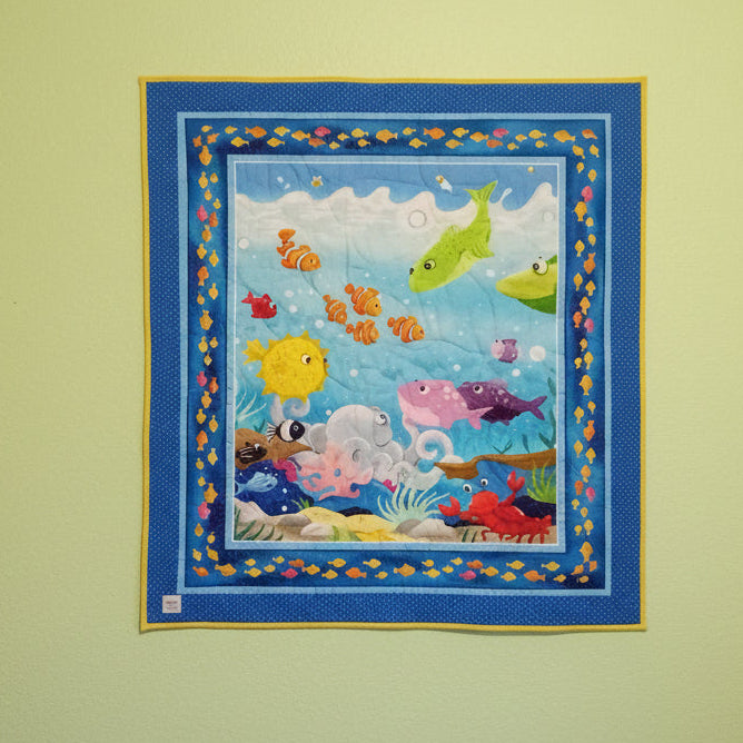 Children's educational rug with colorful sea-themed design on a carpeted floor.