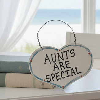 Heart-shaped sign with 'Aunts are special' text on a white background