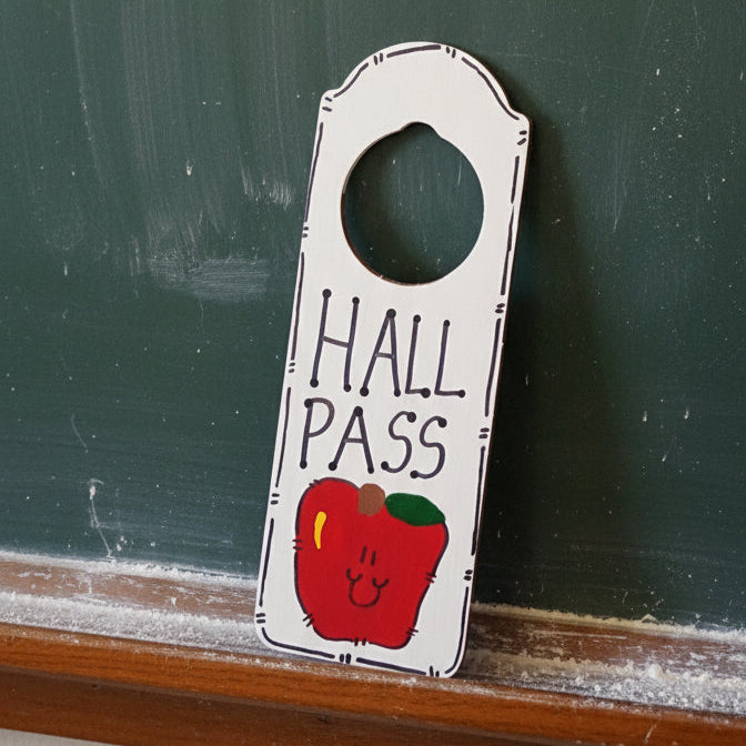 Hall pass with a red apple design on a white background