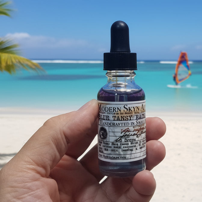 Hand holding a small bottle labeled 'Modern Sprout' with a dropper against a neutral background.