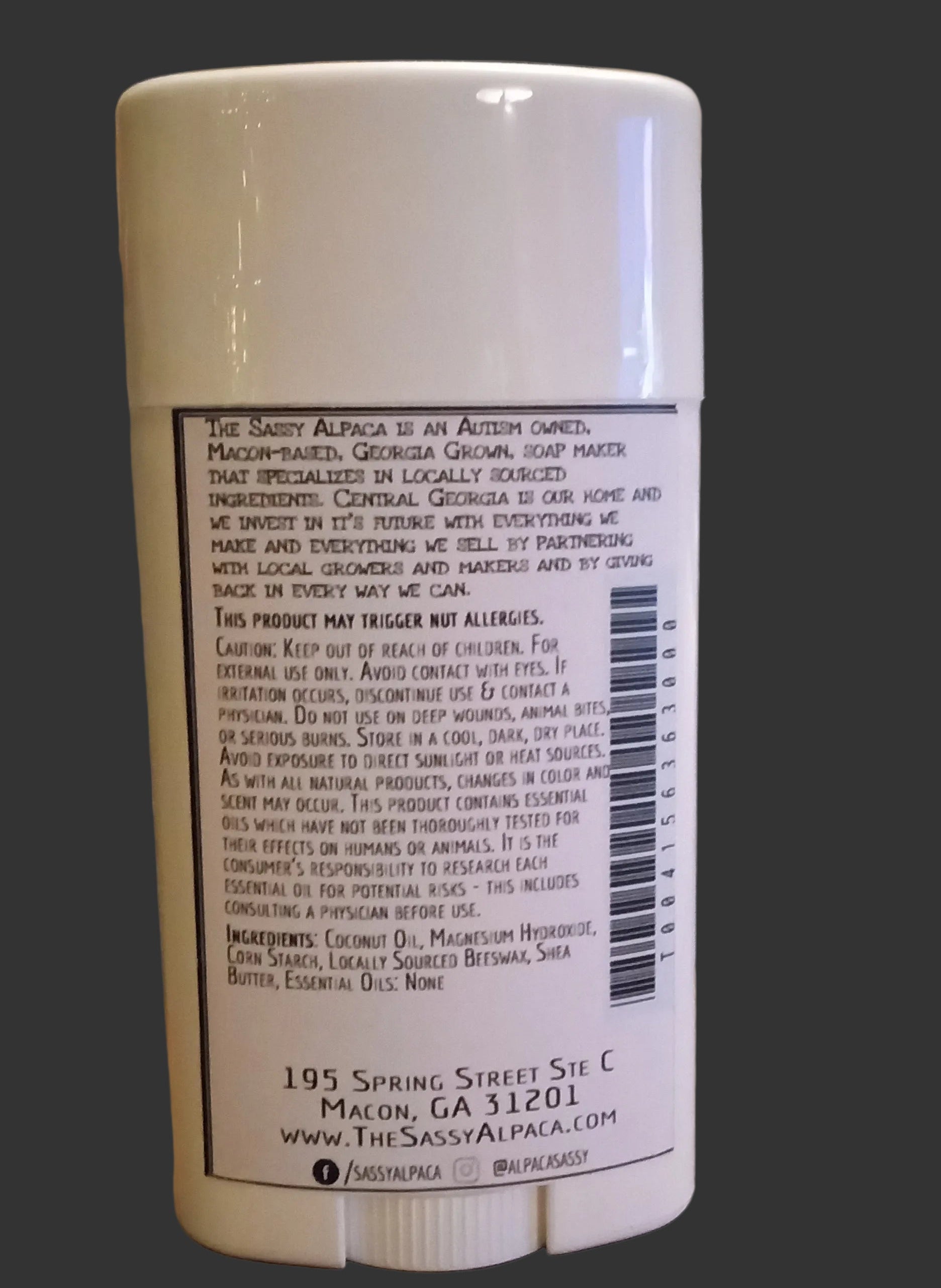 White cylindrical container with text on a dark background