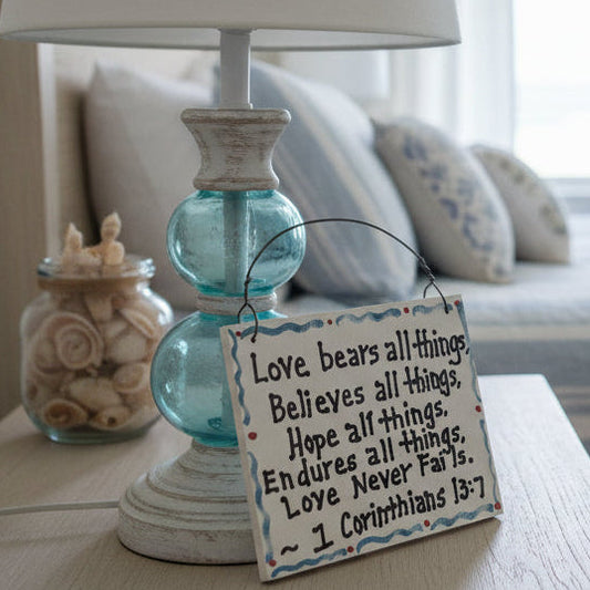 Hand holding a sign with a quote against a white background