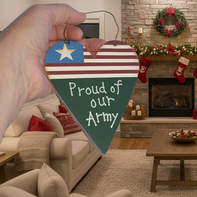 Decorated living room with Christmas tree, stockings, and a heart-shaped sign with 'Proud of our Army' text.