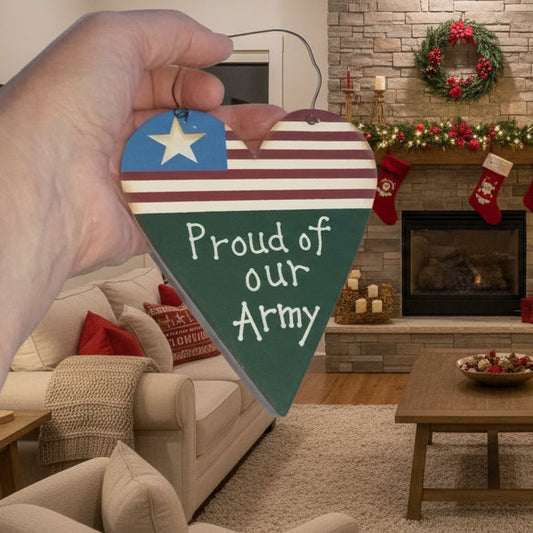 Decorated living room with Christmas tree, stockings, and a heart-shaped sign with 'Proud of our Army' text.