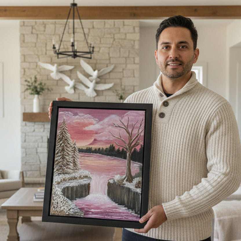 man holding framed artwork