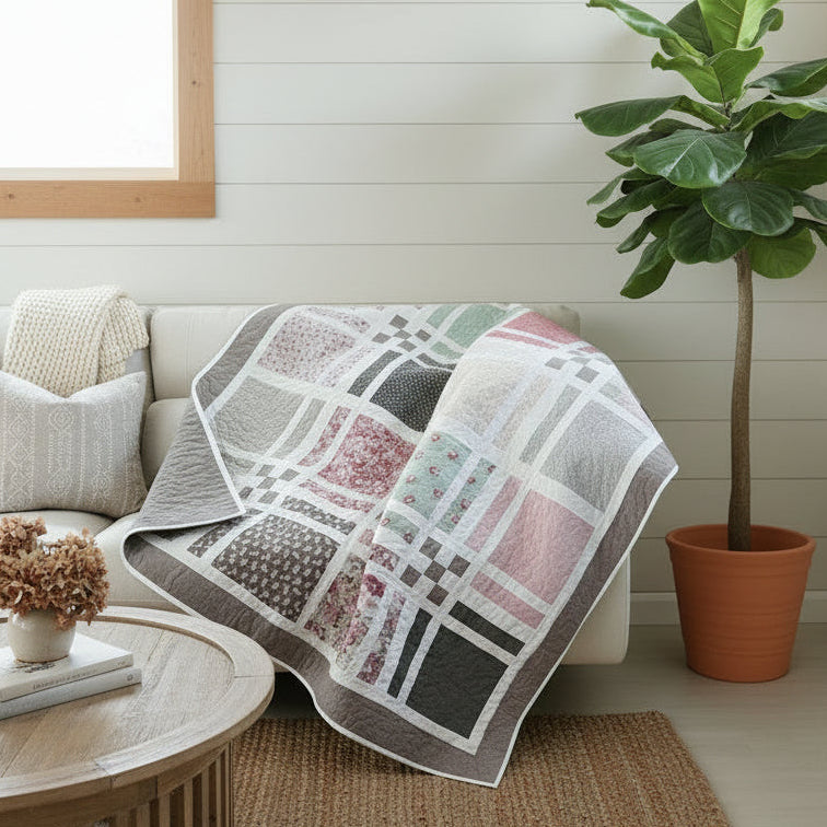 Patchwork quilt with geometric pattern draped over a couch.