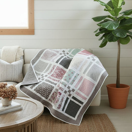 Patchwork quilt with geometric pattern draped over a couch.