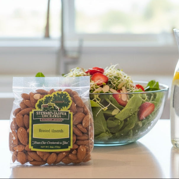 Packaged almonds with a salad and lemon water in the background