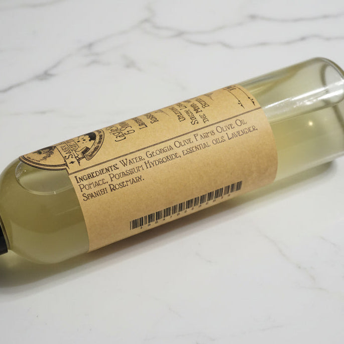 Bottle of olive oil with a label on a marble surface