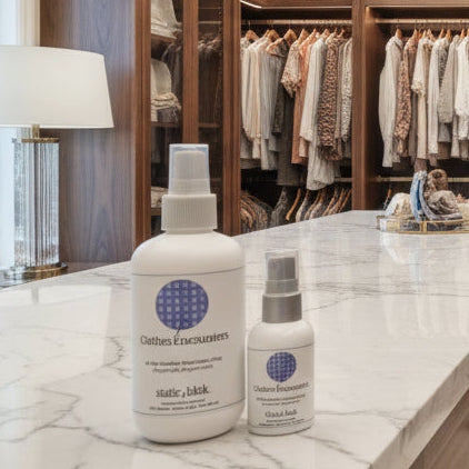Modern walk-in closet with wooden shelves and clothing, featuring a countertop with bottles.