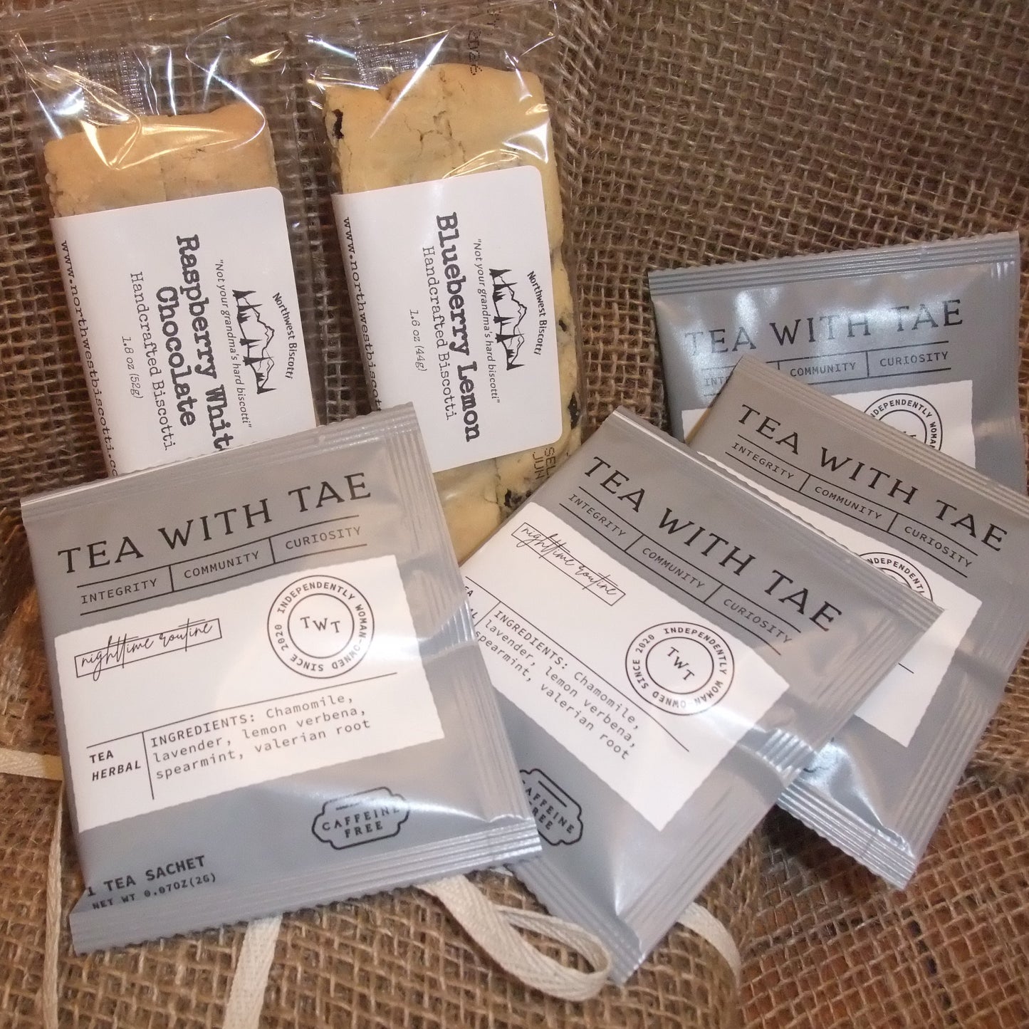 Tea packages with visible branding on a textured fabric background