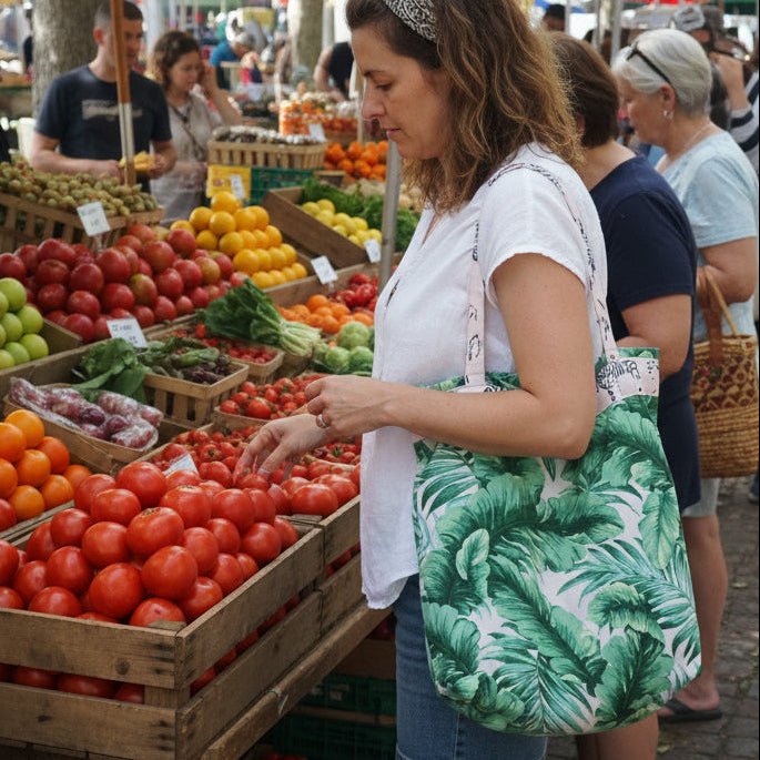 Green fabric bag with leaf pattern on a wooden surface