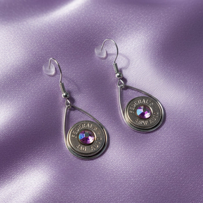 Pair of earrings with gemstones on a white surface