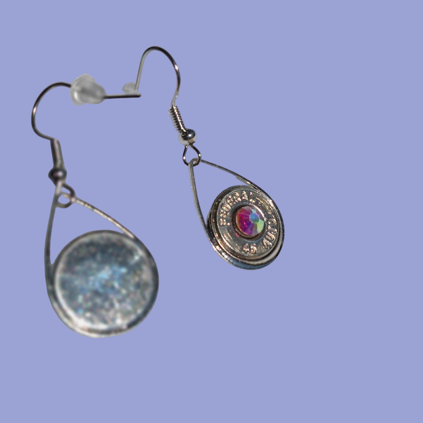 Silver earrings with a colorful gemstone on a white background