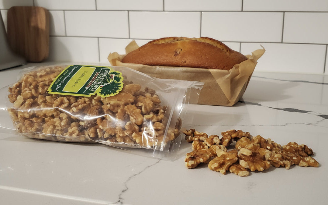 Bag of walnuts on a kitchen counter with scattered walnuts.