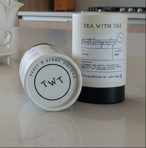 Tea with T and fruit bowl on a kitchen counter