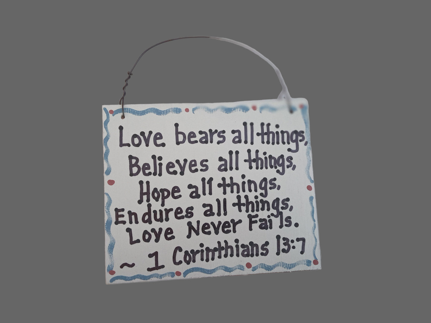 Decorative sign with inspirational quote on a white background