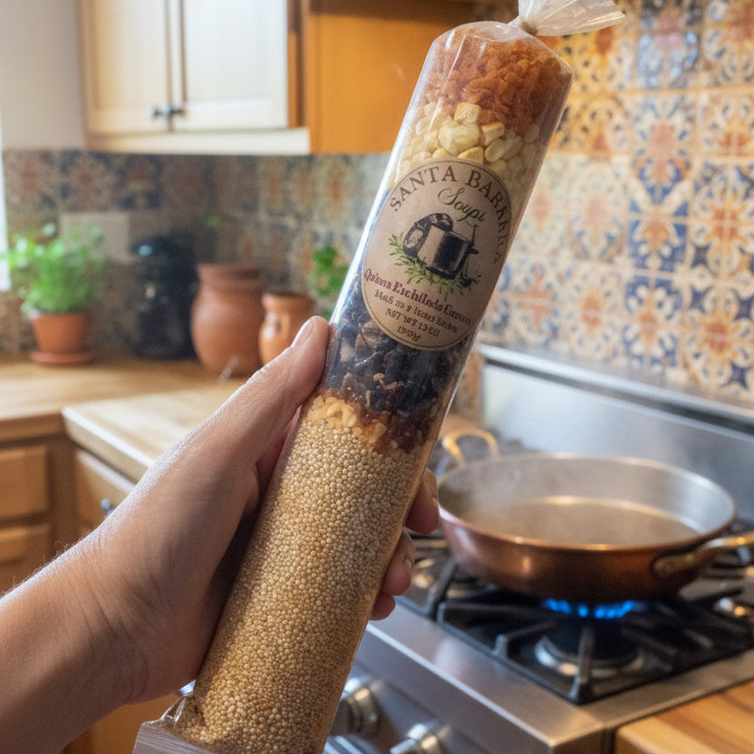 Hand holding a cylindrical product wrapped in gold paper against a plain background